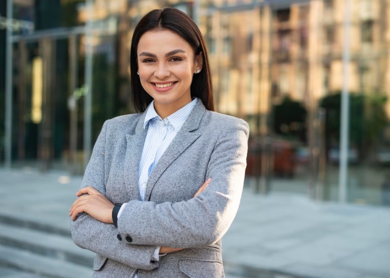 smiley-businesswoman-posing-outdoors-with-arms-crossed-copy-space_23-2148767055